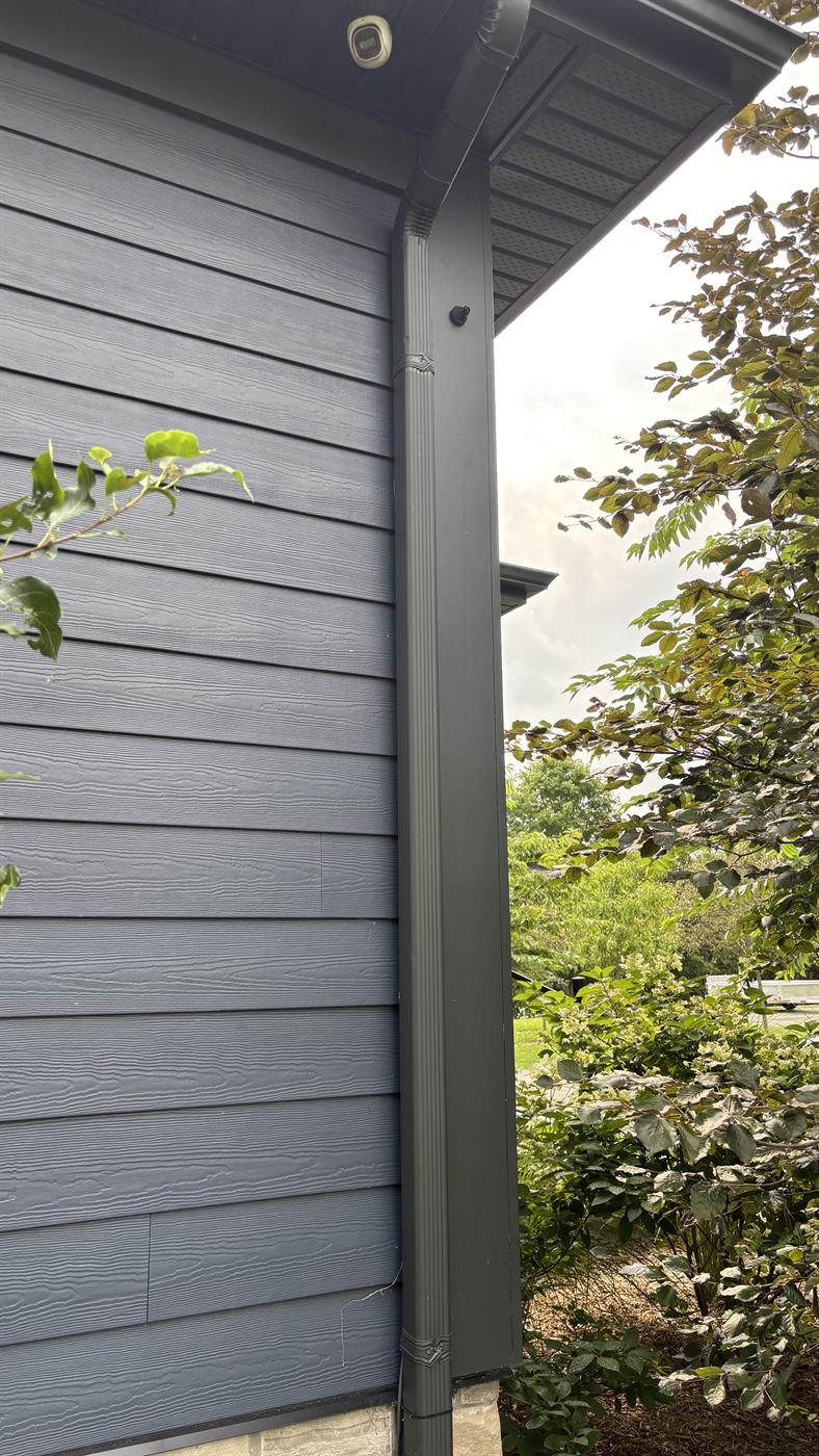 Starlink cable run tucked along the downspout on the siding of a Milton house