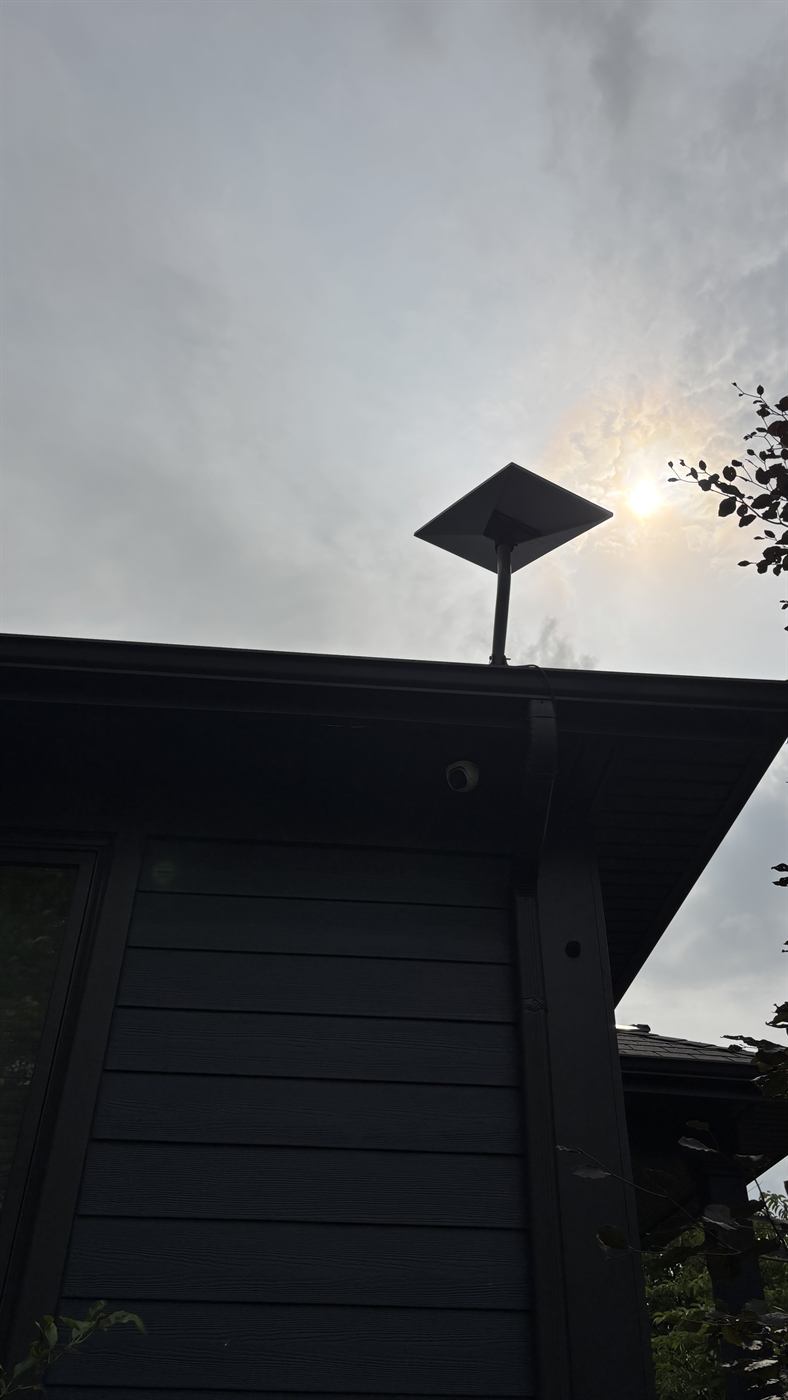 Starlink dish on a short mast at the roof edge of a Milton home, clear of the tree line